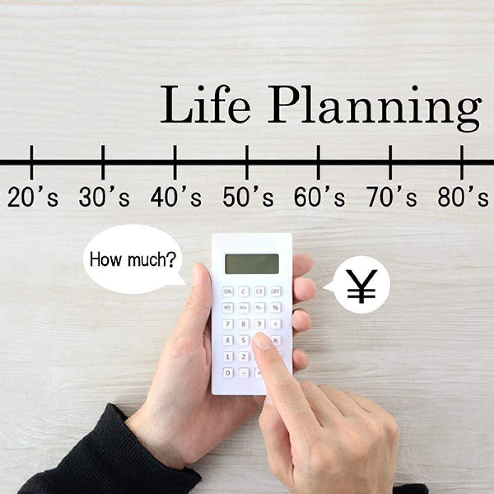 Human's hands using calculator with life planning scale